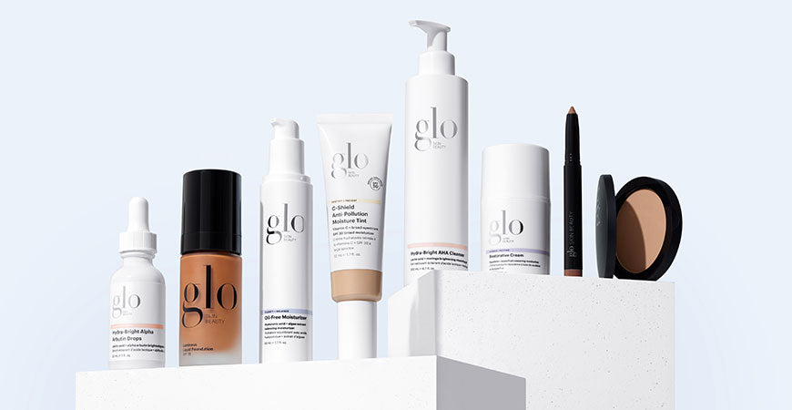 Lineup of Glo Skin Beauty skincare and makeup products including Hydro-Bright Alpha Arbutin Drops, C-Shield Anti-Pollution Moisture Tint, and others.
