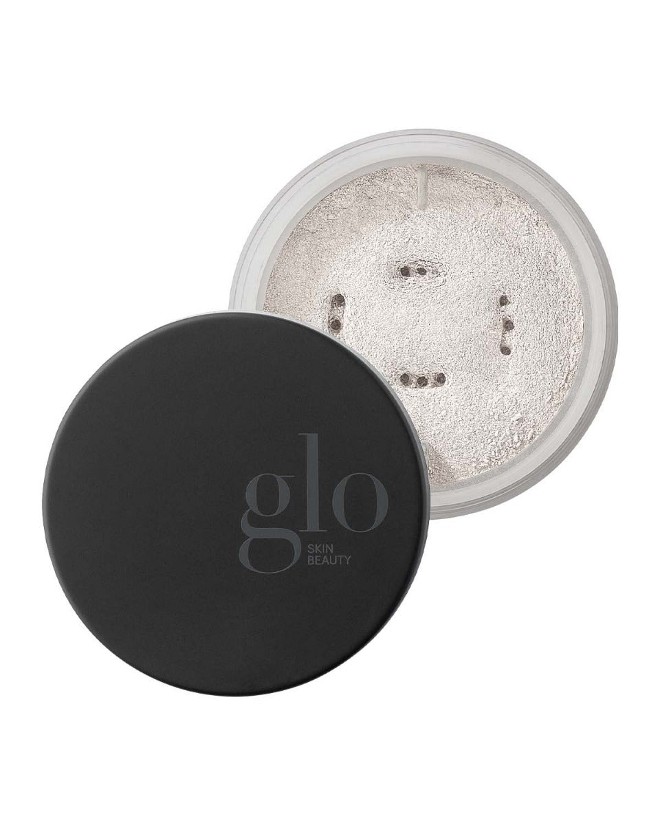 Open container of luminous setting powder with black lid labeled 'glo SKIN BEAUTY'